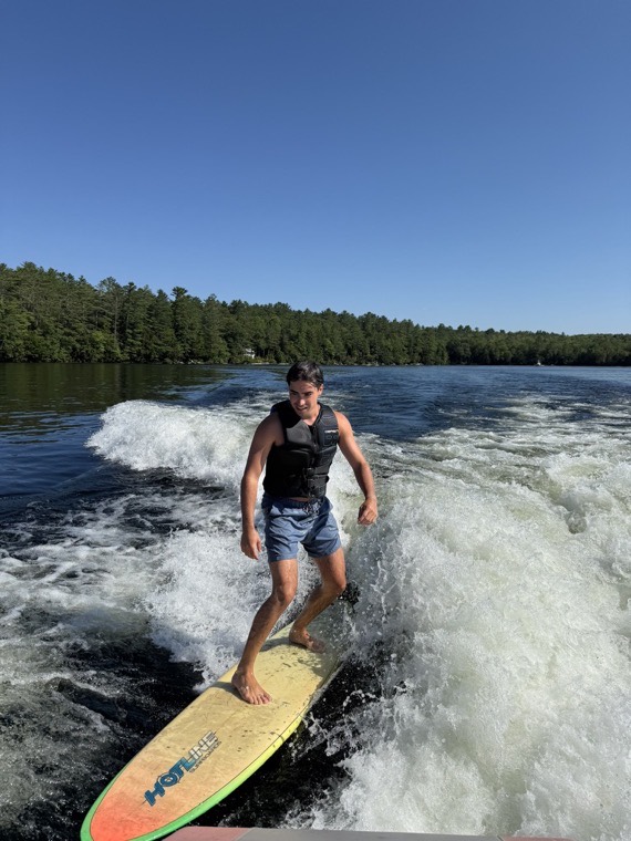 Wakesurfing behind a boat.