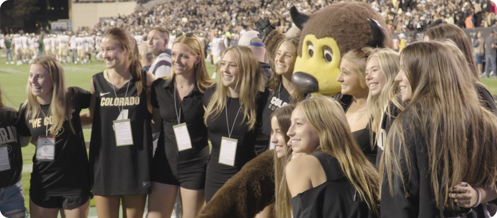 Graduating students and the CU Boulder mascot on Folsom Field, a still from the commencement film.